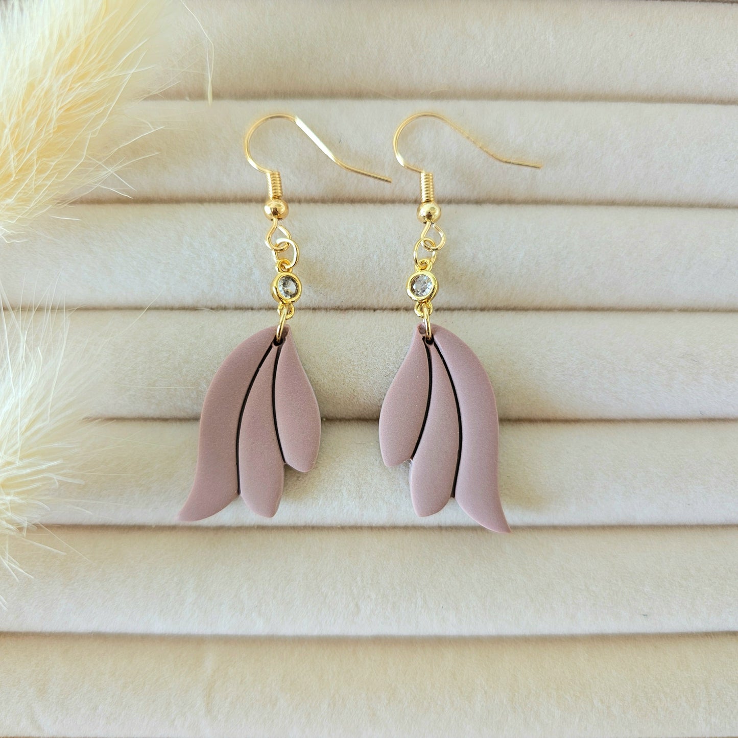 Pink feather-shaped earrings with gold hooks