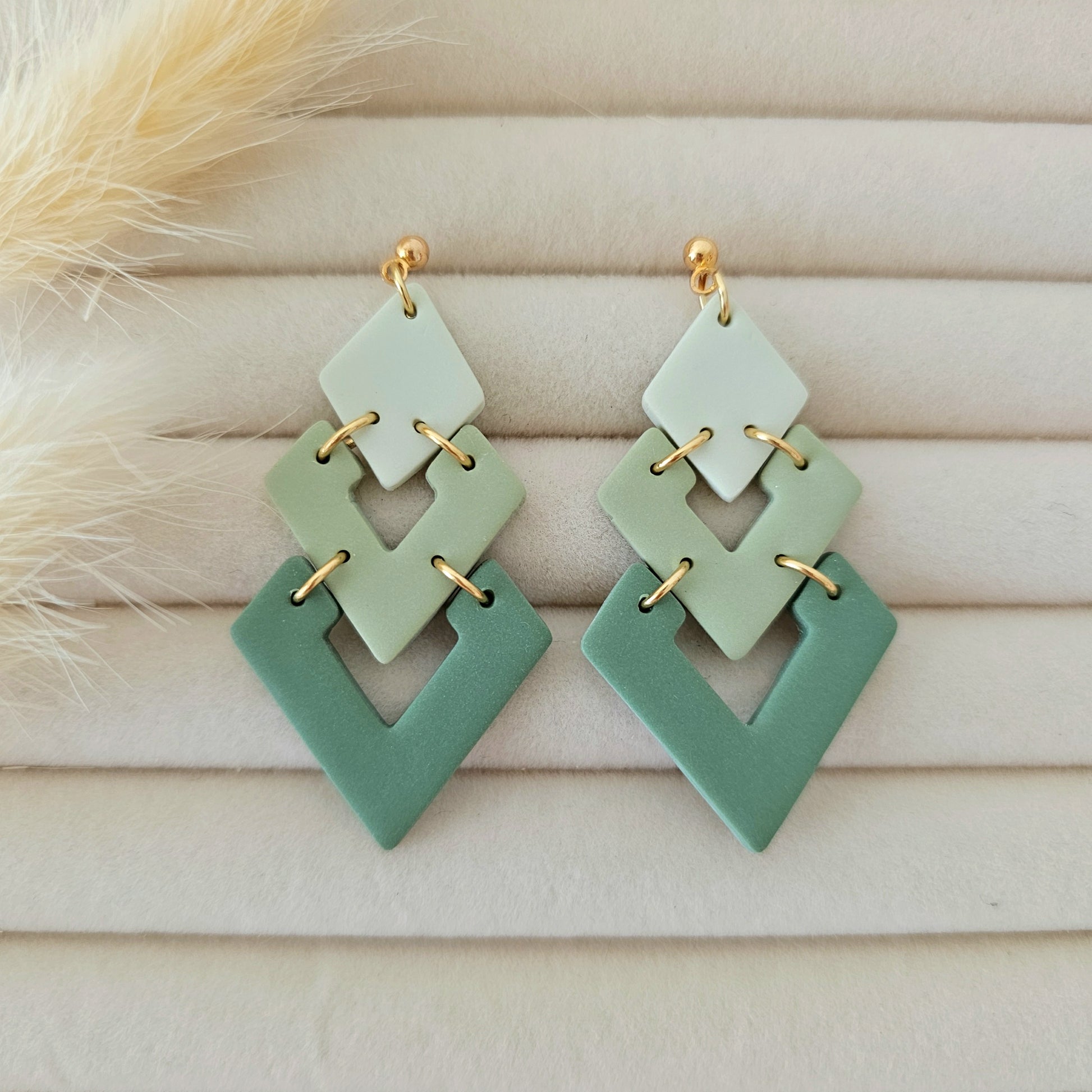 Pair of green earrings with gold accents