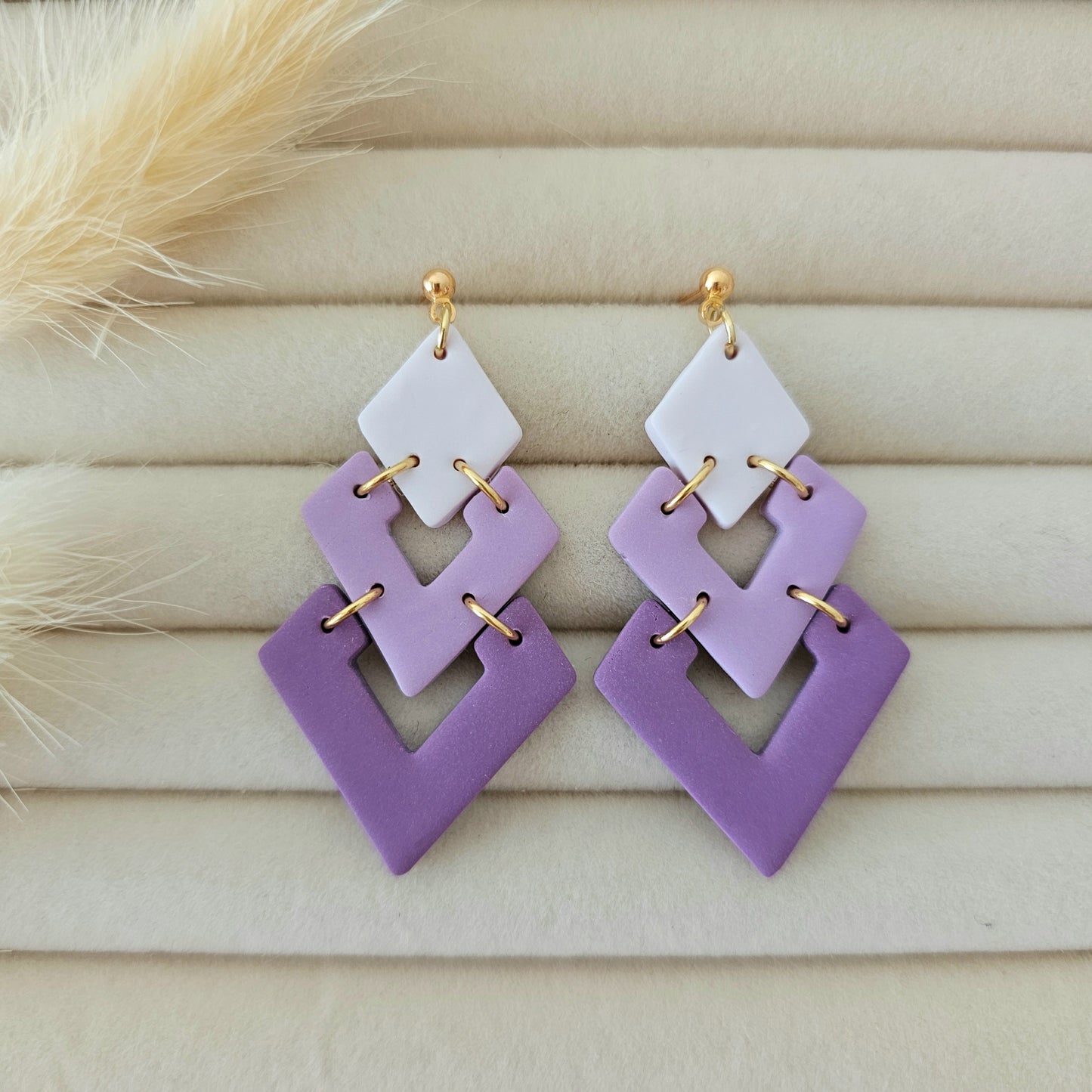 Pair of geometric earrings with purple and white squares
