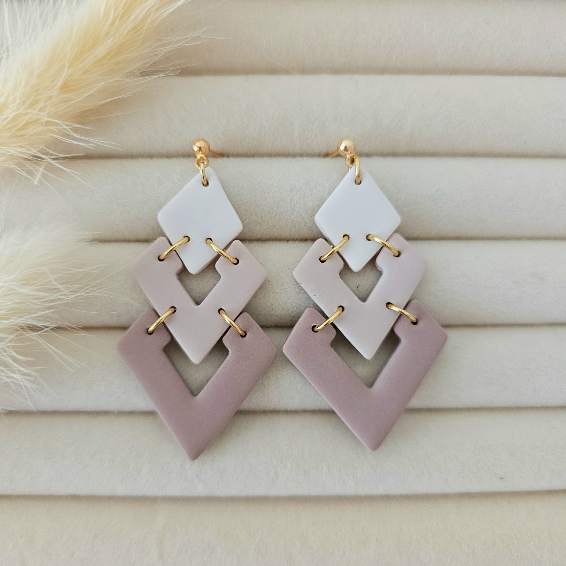 Geometric earrings on a wooden surface